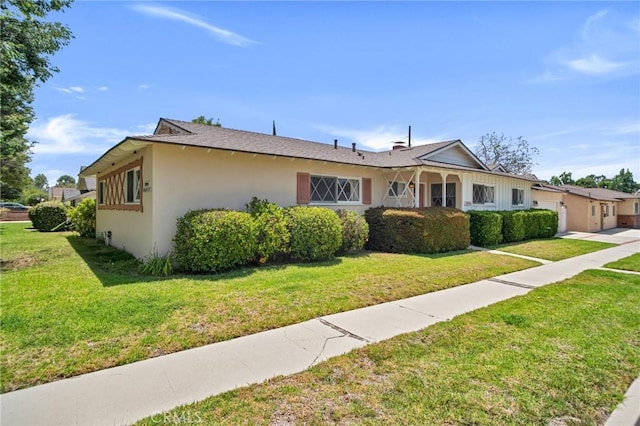 18944 Prairie St, Northridge, CA 91324 - view of front facade with a garage, stucco siding, and a front lawn