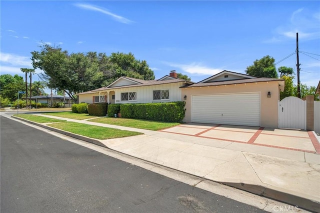 18944 Prairie St, Northridge, CA 91324 - ranch-style house with a gate, concrete driveway, a garage, and a front yard