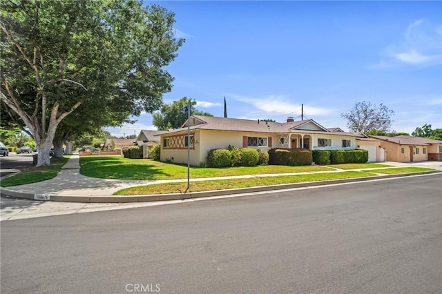 18944 Prairie St, Northridge, CA 91324 - single story home with a front yard, an attached garage, and stucco siding