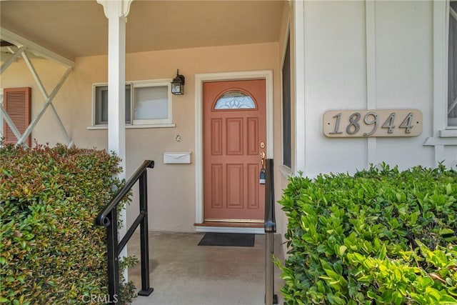 18944 Prairie St, Northridge, CA 91324 - doorway to property with stucco siding