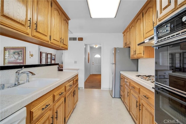 18944 Prairie St, Northridge, CA 91324 - kitchen with white appliances, brown cabinets, and under cabinet range hood