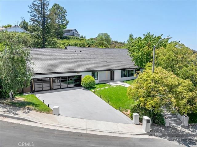 20101 Greenbriar Dr, Tarzana, CA 91356 - single story home featuring an attached garage, driveway, a front yard, and stucco siding