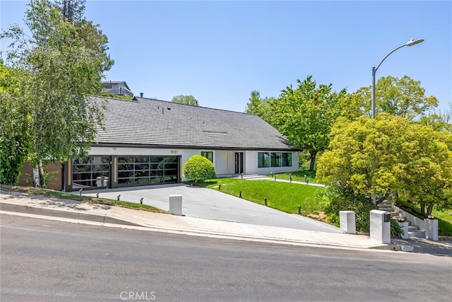 20101 Greenbriar Dr, Tarzana, CA 91356 - view of front of home featuring concrete driveway, a front yard, and a garage