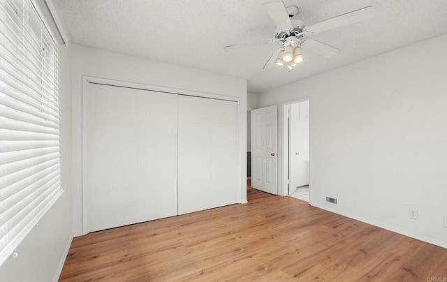 3168 Florine Dr, Lemon Grove, CA 91945 - unfurnished bedroom featuring light wood-type flooring, a closet, a textured ceiling, and a ceiling fan