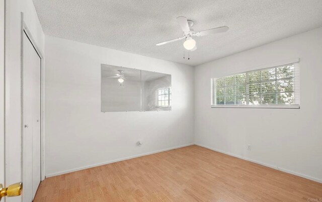 3168 Florine Dr, Lemon Grove, CA 91945 - unfurnished bedroom with a textured ceiling, light wood-type flooring, a closet, and a ceiling fan