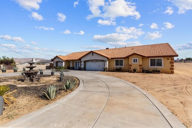 17635 Verde St, Hesperia, CA 92345 - single story home featuring stucco siding, curved driveway, a tile roof, and a garage