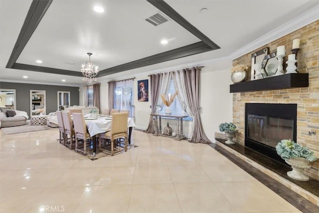17635 Verde St, Hesperia, CA 92345 - dining area with a tray ceiling, ornamental molding, a chandelier, a large fireplace, and tile patterned floors