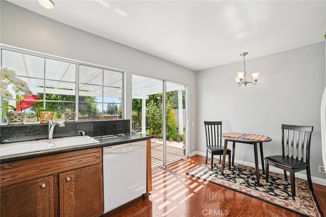 23441 Via Ronda, Mission Viejo, CA 92691 - kitchen with dishwasher, dark wood-style flooring, a chandelier, dark countertops, and brown cabinetry