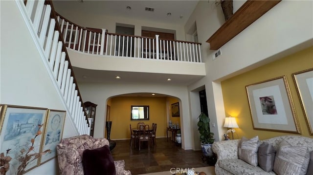 28107 Graciosa St, Valencia, CA 91355 - living area with arched walkways, stairway, and a towering ceiling