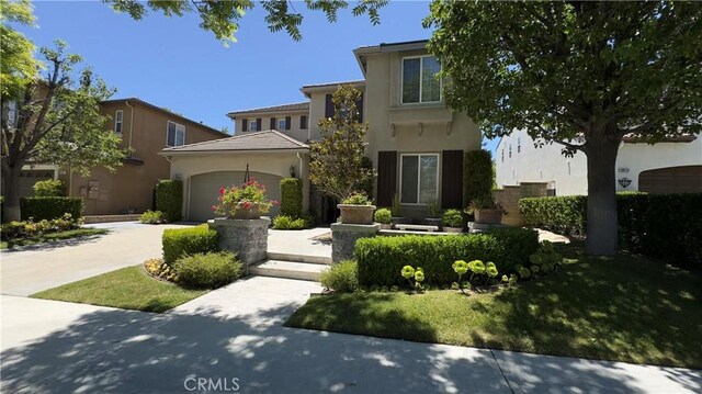 28107 Graciosa St, Valencia, CA 91355 - view of front of house with stucco siding, a garage, and concrete driveway