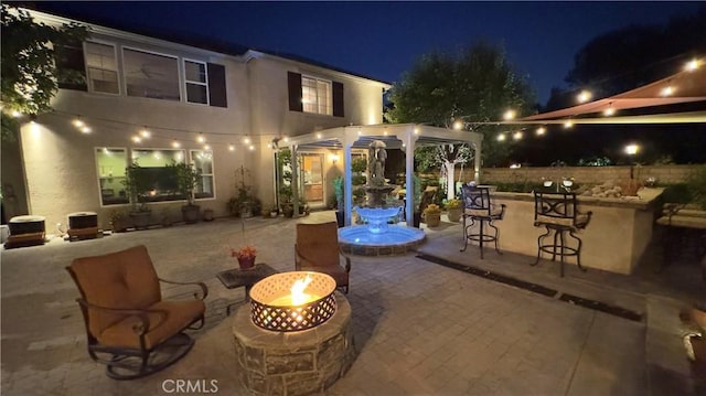 28107 Graciosa St, Valencia, CA 91355 - patio at night featuring a patio, a fire pit, and a bar