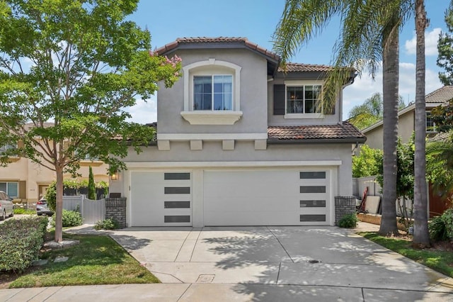 5414 Foxtail Loop, Carlsbad, CA 92010 - mediterranean / spanish-style house with a tiled roof, an attached garage, stucco siding, and driveway