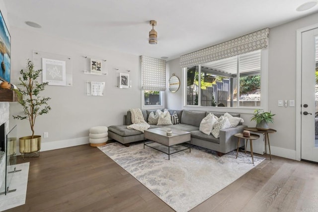 5414 Foxtail Loop, Carlsbad, CA 92010 - living area featuring wood finished floors, plenty of natural light, and a fireplace with raised hearth