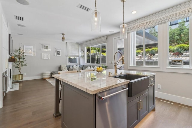 5414 Foxtail Loop, Carlsbad, CA 92010 - kitchen featuring stainless steel dishwasher, dark wood finished floors, pendant lighting, a center island with sink, and recessed lighting