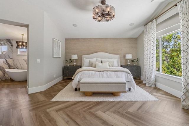 5414 Foxtail Loop, Carlsbad, CA 92010 - bedroom with an accent wall, a chandelier, vaulted ceiling, and wallpapered walls