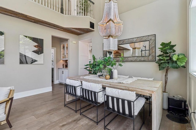 5414 Foxtail Loop, Carlsbad, CA 92010 - dining space featuring a chandelier, wood finished floors, and a high ceiling