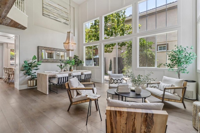 5414 Foxtail Loop, Carlsbad, CA 92010 - living area featuring a high ceiling, healthy amount of natural light, and hardwood / wood-style floors