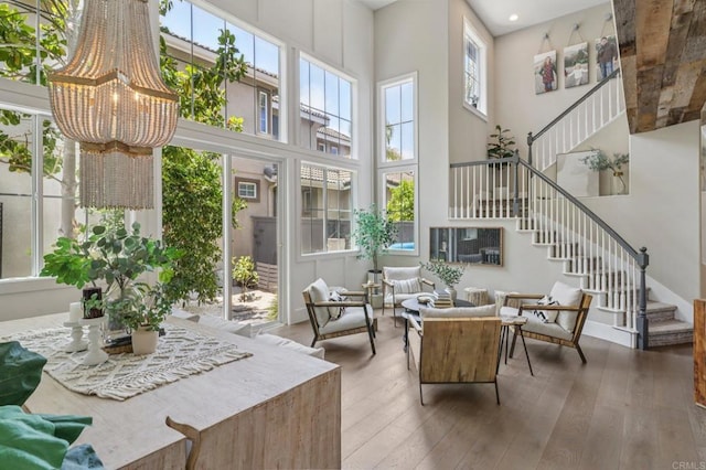 5414 Foxtail Loop, Carlsbad, CA 92010 - living area with stairway, a towering ceiling, hardwood / wood-style flooring, a chandelier, and recessed lighting