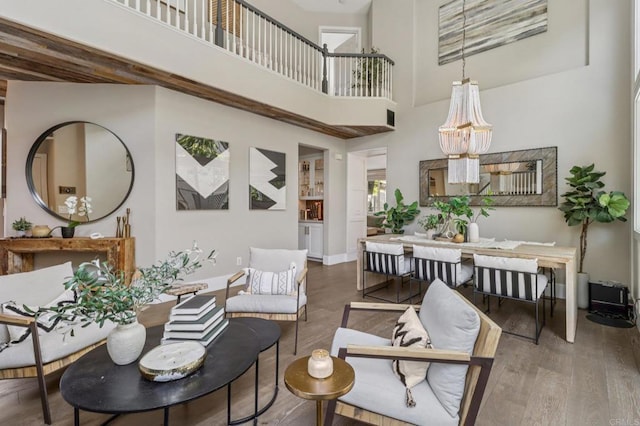 5414 Foxtail Loop, Carlsbad, CA 92010 - living area with a high ceiling, wood finished floors, and a chandelier