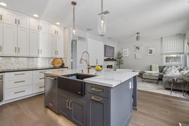 5414 Foxtail Loop, Carlsbad, CA 92010 - kitchen with dark wood finished floors, open floor plan, tasteful backsplash, dishwasher, and white cabinetry