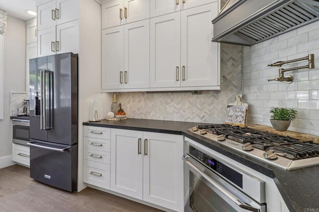 5414 Foxtail Loop, Carlsbad, CA 92010 - kitchen with stainless steel appliances, custom range hood, dark countertops, and backsplash