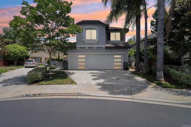 5414 Foxtail Loop, Carlsbad, CA 92010 - view of front of property with stucco siding, an attached garage, concrete driveway, and a tiled roof
