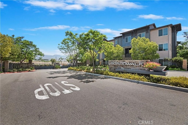 677 Savi Dr Unit 101, Corona, CA 92878 - view of asphalt road featuring a gated entry and curbs