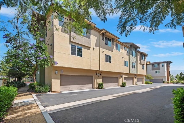 677 Savi Dr Unit 101, Corona, CA 92878 - view of building exterior with a garage and a residential view
