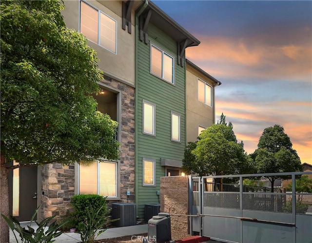 677 Savi Dr Unit 101, Corona, CA 92878 - back of property at dusk with stone siding and stucco siding