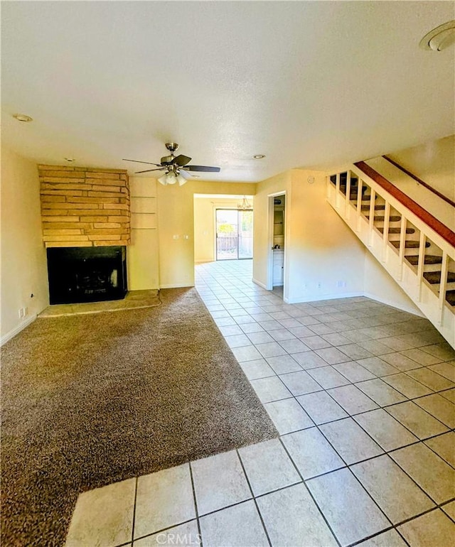 1107 Grieb Dr, Arroyo Grande, CA 93420 - unfurnished living room featuring a ceiling fan, a fireplace, tile patterned flooring, stairway, and carpet flooring