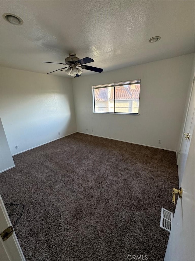 1107 Grieb Dr, Arroyo Grande, CA 93420 - empty room with ceiling fan, dark colored carpet, and a textured ceiling