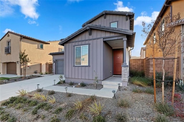 2275 Melogold Way, Corona, CA 92883 - view of front of property with board and batten siding, a garage, and concrete driveway