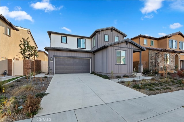 2275 Melogold Way, Corona, CA 92883 - view of front of house with board and batten siding, driveway, and a garage
