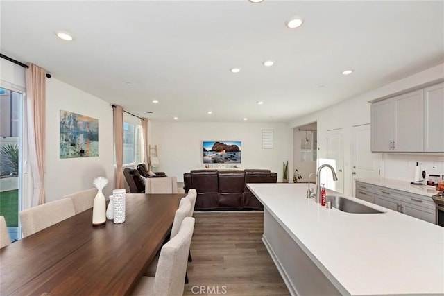 2275 Melogold Way, Corona, CA 92883 - kitchen with wood finished floors, recessed lighting, light countertops, gray cabinets, and a kitchen island with sink