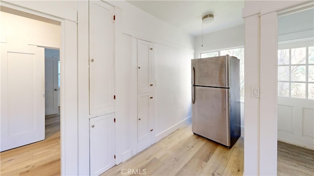 1143 N Sycamore Ave, Los Angeles, CA 90038 - kitchen featuring freestanding refrigerator, light wood-style floors, and plenty of natural light