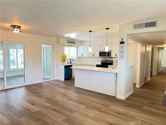 29041 Desert Hills Rd, Menifee, CA 92586 - kitchen featuring electric range, stainless steel microwave, dishwashing machine, and dark wood-type flooring
