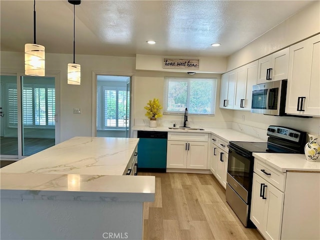 29041 Desert Hills Rd, Menifee, CA 92586 - kitchen with electric range oven, stainless steel microwave, dishwashing machine, a kitchen island, and light wood finished floors