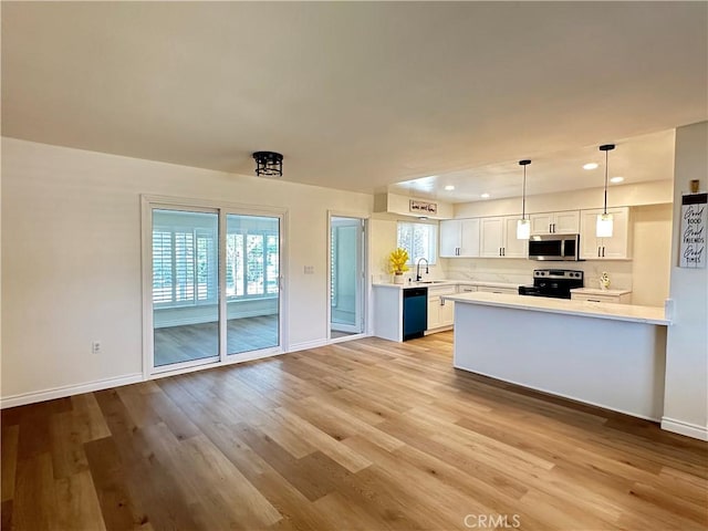 29041 Desert Hills Rd, Menifee, CA 92586 - kitchen with appliances with stainless steel finishes, light countertops, light wood-style flooring, white cabinets, and recessed lighting