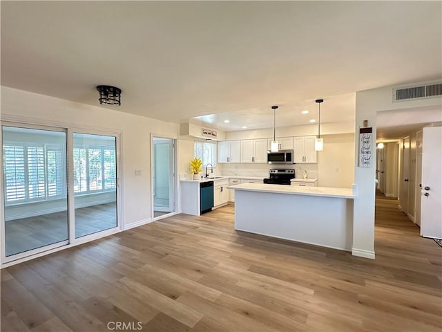 29041 Desert Hills Rd, Menifee, CA 92586 - kitchen featuring black dishwasher, range with electric stovetop, stainless steel microwave, light countertops, and plenty of natural light