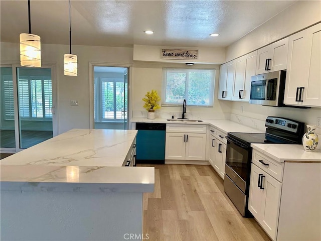 29041 Desert Hills Rd, Menifee, CA 92586 - kitchen featuring stainless steel microwave, range with electric cooktop, dishwashing machine, a center island, and light wood-type flooring