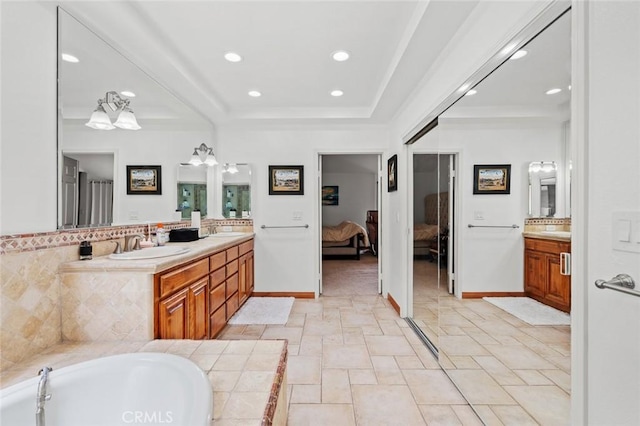 22410 Starwood Dr, Yorba Linda, CA 92887 - ensuite bathroom with vanity, a tray ceiling, recessed lighting, and a tub to relax in