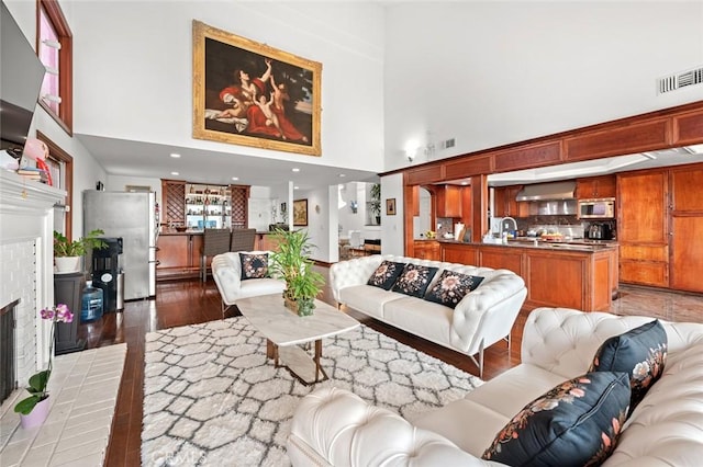 22410 Starwood Dr, Yorba Linda, CA 92887 - living room with a towering ceiling, light wood-style flooring, and a fireplace