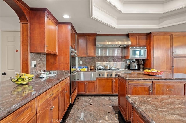 22410 Starwood Dr, Yorba Linda, CA 92887 - kitchen with stainless steel appliances, wall chimney range hood, ornamental molding, brown cabinets, and dark stone counters
