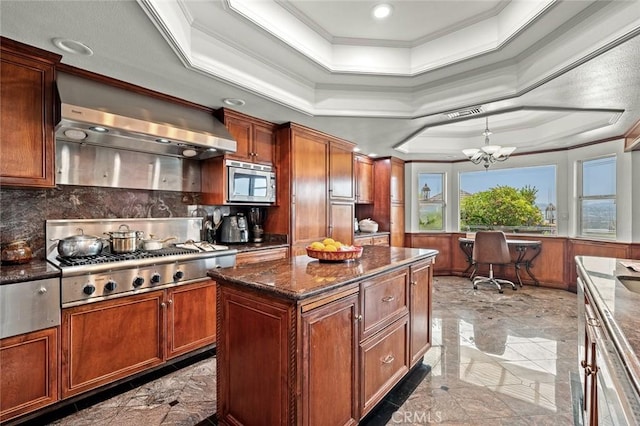 22410 Starwood Dr, Yorba Linda, CA 92887 - kitchen with wall chimney range hood, crown molding, stainless steel appliances, a tray ceiling, and dark marble finish floors