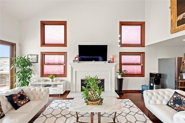 22410 Starwood Dr, Yorba Linda, CA 92887 - living area with high vaulted ceiling, wood finished floors, and a brick fireplace
