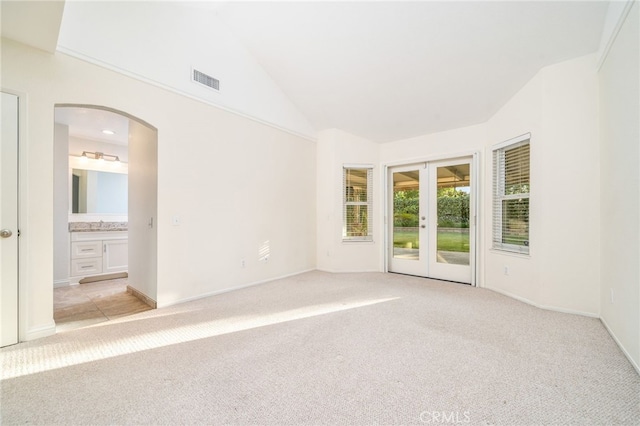 6001 Via De Mansion, La Verne, CA 91750 - spare room featuring light colored carpet, french doors, vaulted ceiling, and arched walkways