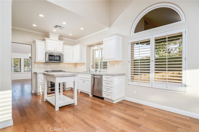 6001 Via De Mansion, La Verne, CA 91750 - kitchen featuring appliances with stainless steel finishes, crown molding, white cabinetry, tasteful backsplash, and recessed lighting