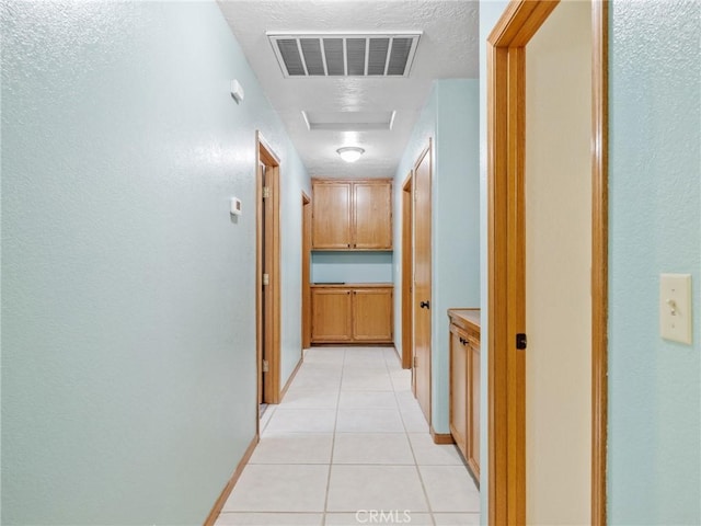 7556 Glider Ave, Hesperia, CA 92345 - corridor with attic access and light tile patterned floors