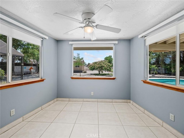 7556 Glider Ave, Hesperia, CA 92345 - tiled spare room featuring ceiling fan and a textured ceiling
