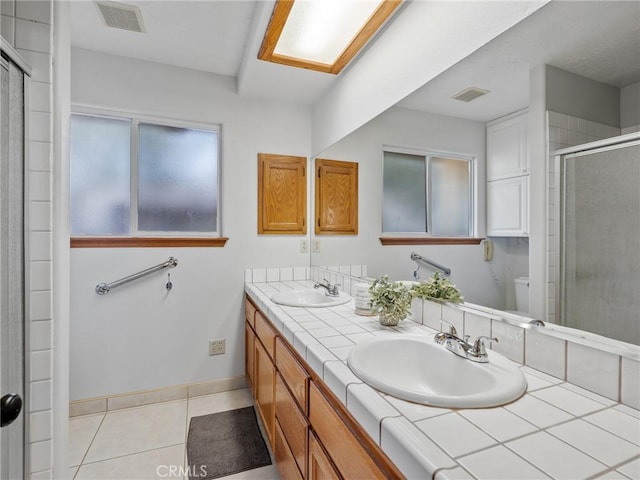 7556 Glider Ave, Hesperia, CA 92345 - bathroom featuring double vanity, a shower stall, and tile patterned floors